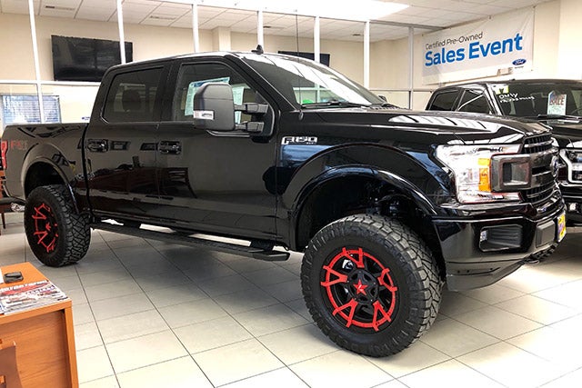 Black F-150 with Jimmie Allen Red Rims at All American Auto Group in Old Bridge NJ